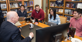 staff sitting around desk